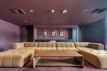 Media lounge with oversized tufted sofa and coffee table